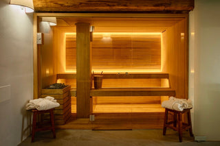 Sauna finlandese privata di Villa Di Valgiano, con panche in legno e porta in vetro.
